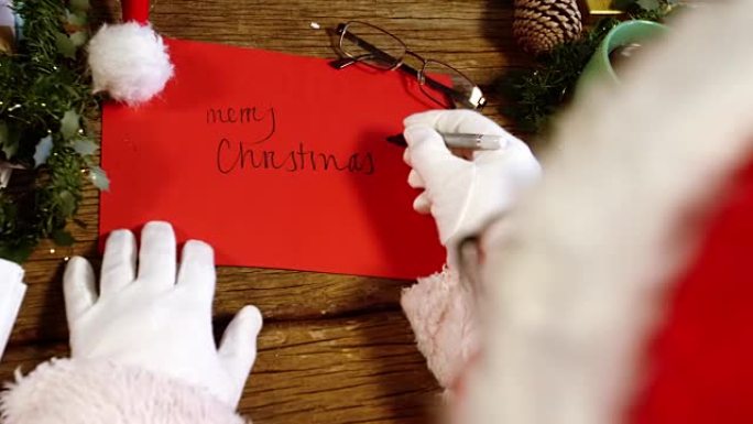圣诞老人在卡片上写圣诞快乐