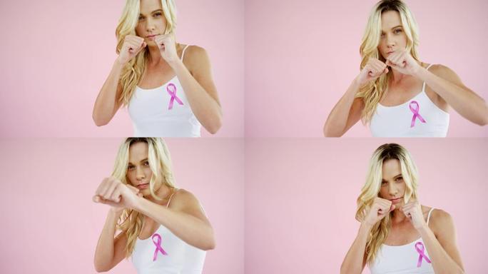 女性乳腺癌意识丝带在粉红色背景下打孔