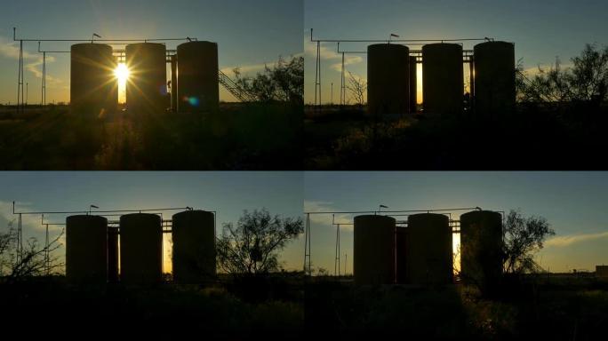 夕阳照耀着大油泵和储油器容器