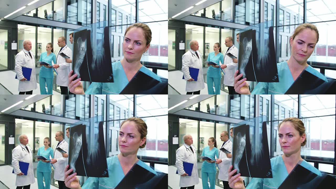 护士在走廊检查x射线报告