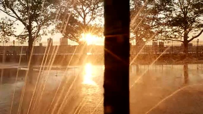 在公园里照亮浪漫的气氛，日落时有一个喷泉，镜头耀斑
