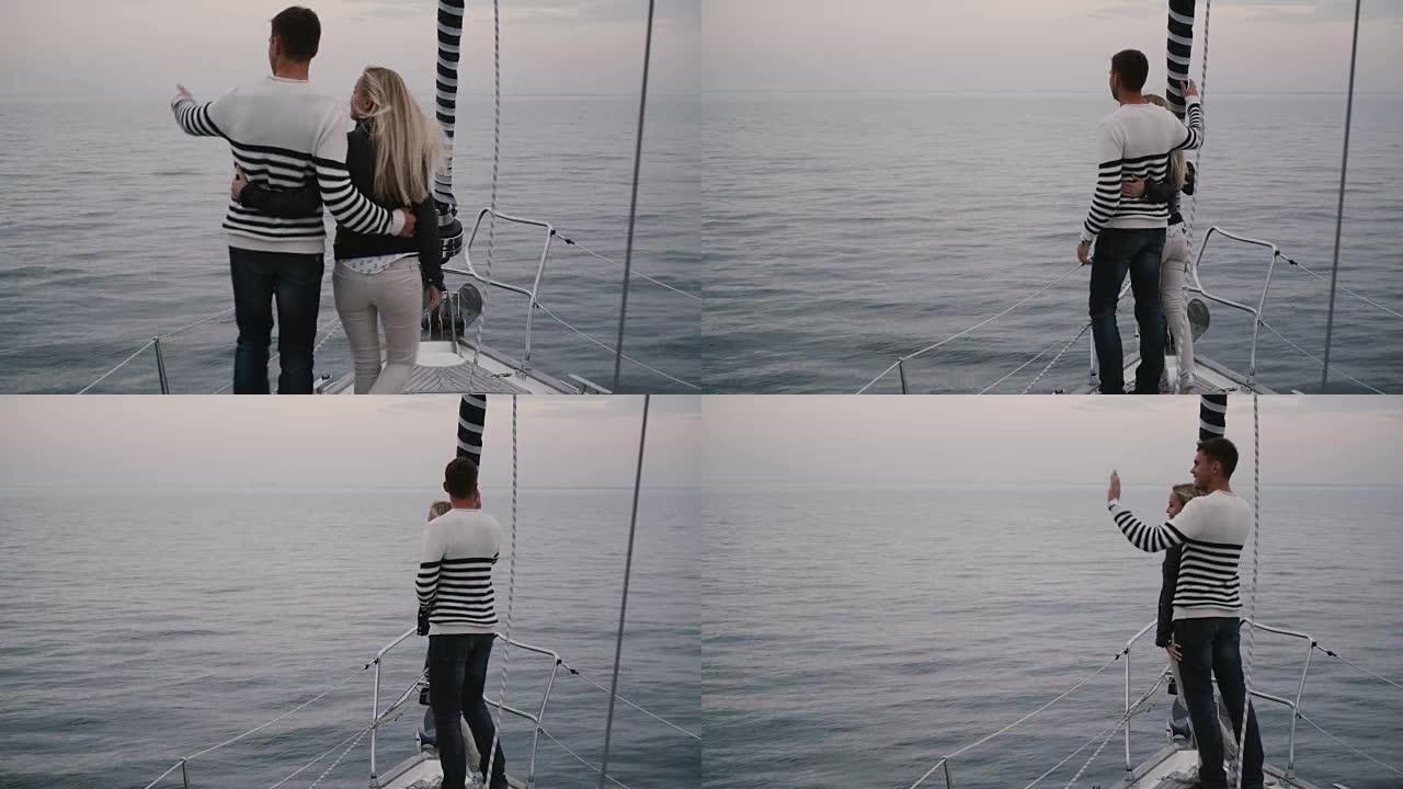 夫妇正在海上的现代帆船上行走。