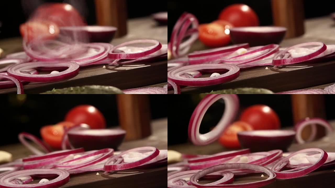 红洋葱圈落在切菜板上slowmo