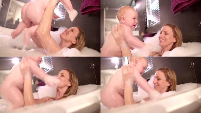 现代妈妈和婴儿女儿一起泡泡浴