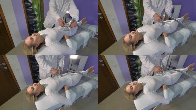 一个女人放松下来接受腹部液化石油气按摩。