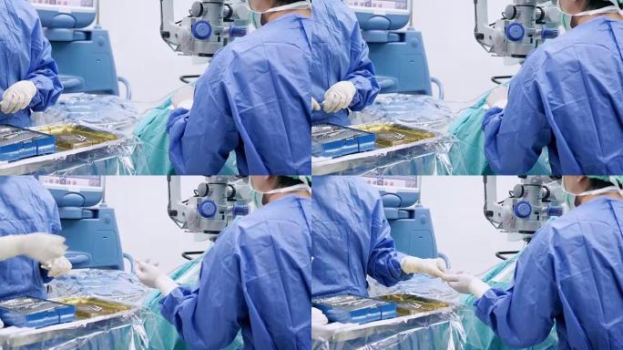 仪器护士为眼科医生外科医生添加手术工具，在手术过程中faco机器的打字监视器触摸屏眼，白内障手术，特