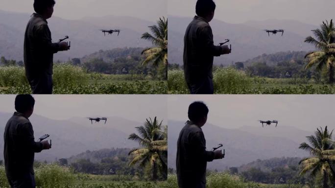 真正的亚洲农民飞行员使用无人机遥控器