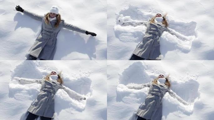 慢动作: 女人跳入雪地并成为天使