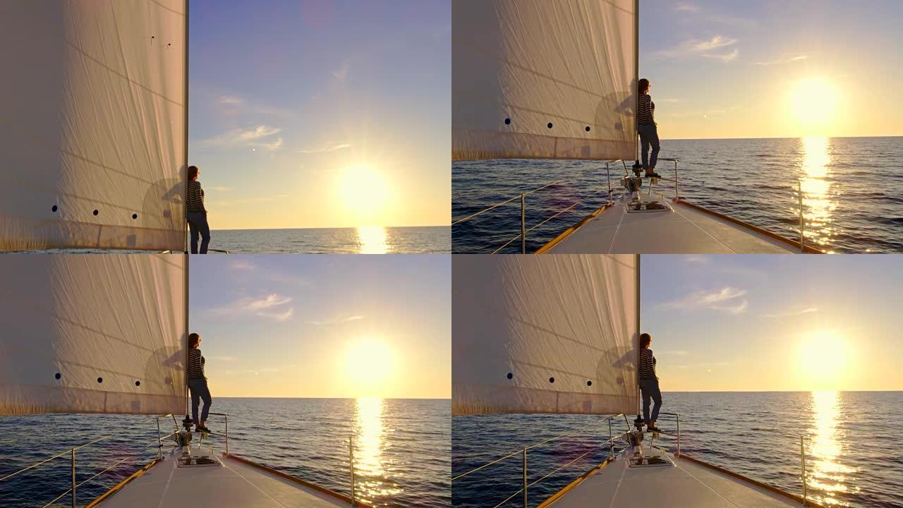 日落时从桅杆到帆船上的女人