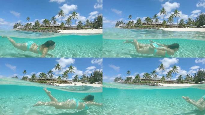 半水下开朗的女游客去玻璃海放松潜水。