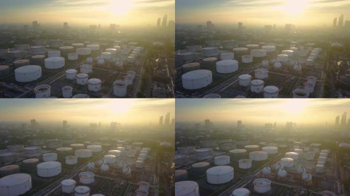 城市日出时带储罐的化工或炼油厂的鸟瞰图