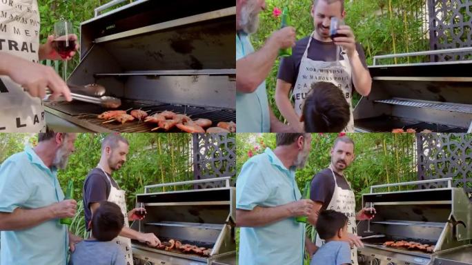 三代澳大利亚家庭男子在烧烤中做饭时用饮料敬酒