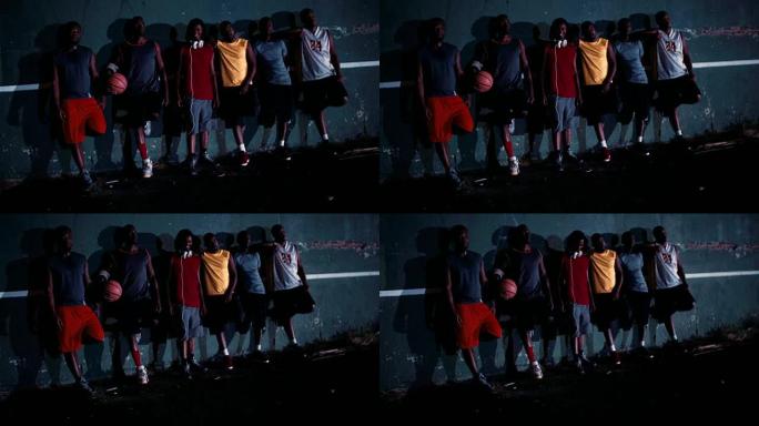 一群篮球运动员在球场墙上排队