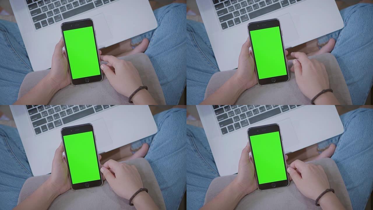 使用智能手机的女性高角度视角，绿屏