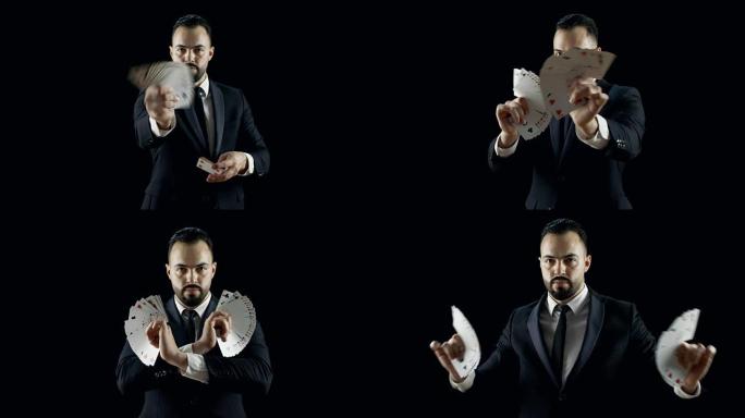 穿着黑色西装的专业魔术师表演纸牌技巧，使纸牌扇出。花招。背景是黑色的。