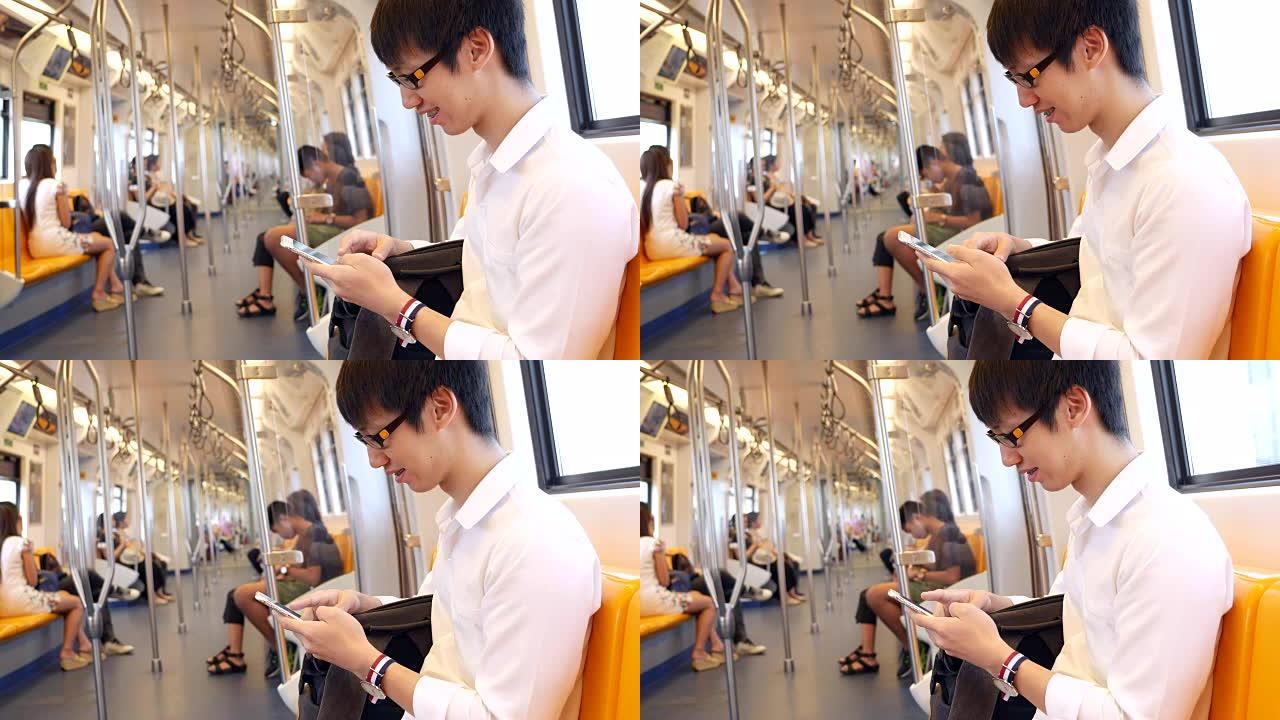 年轻人在火车上使用智能手机