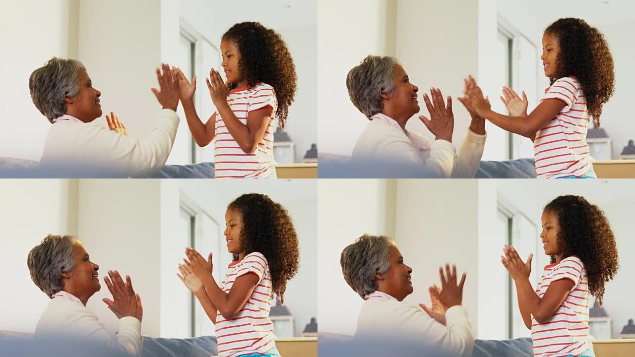 孙女和祖母在客厅玩拍手游戏4k