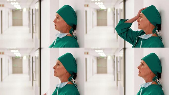 紧张的女外科医生站在走廊上