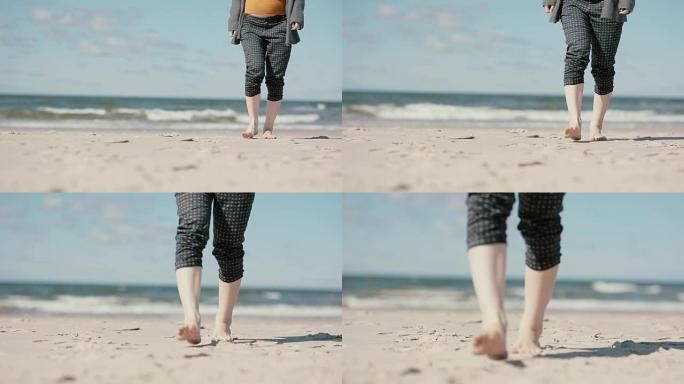 一名孕妇赤脚走在沙滩上，慢慢靠近相机