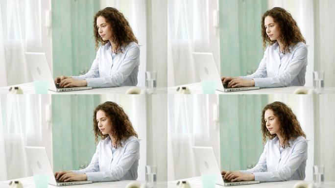女人在笔记本电脑上打字