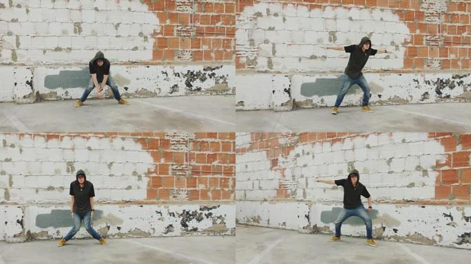 男子嘻哈在砖墙前的城市外面跳舞