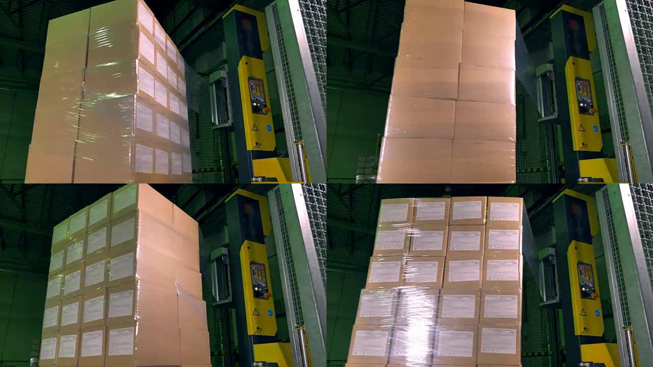 用包裹覆盖旋转盒子的立式机器。