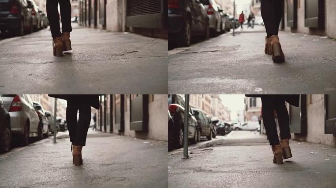 走在小街的时尚女人的特写镜头。穿高跟鞋的女孩穿过这座城市。慢动作