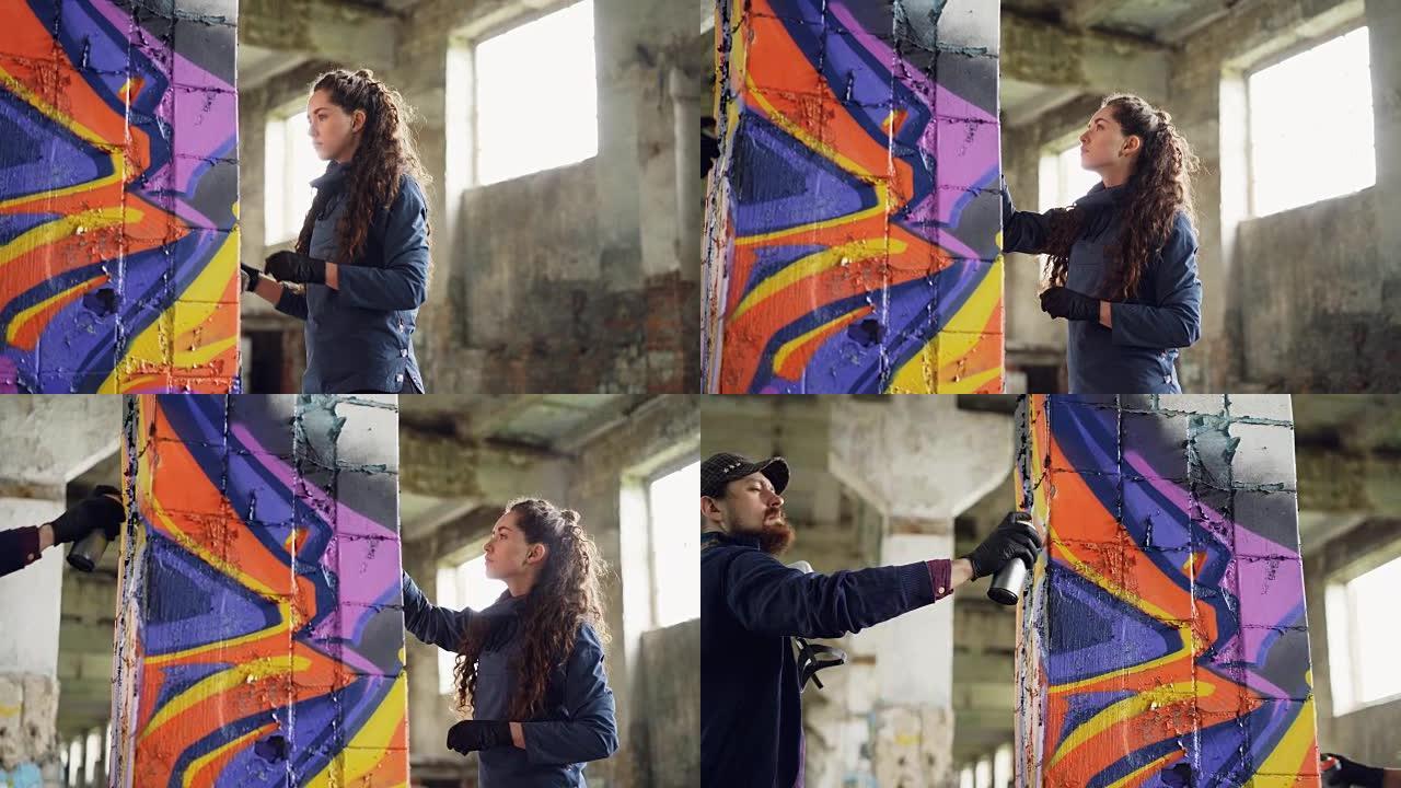 两位朋友的涂鸦画家正在废弃的房子里拿着气溶胶涂料在旧的受损柱子上绘制抽象图像。有创造力的人专注于他们