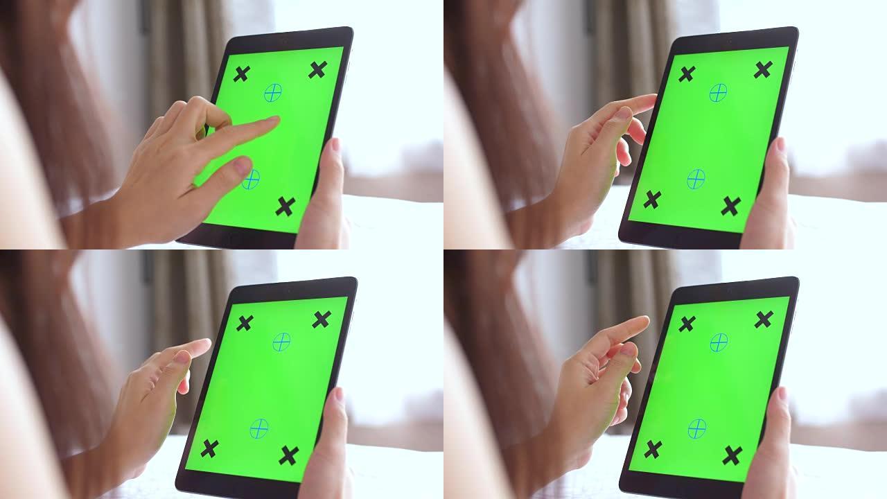女人使用数字平板电脑，绿屏