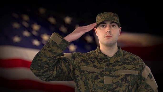 以美国国旗为背景的男性士兵敬礼