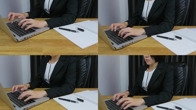 亚洲女性打字笔记本电脑。前视图。从下到上。