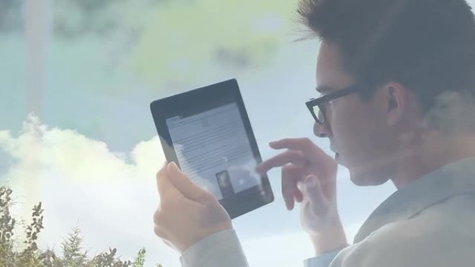 年轻人戴着眼镜使用数码平板电脑，云反射。