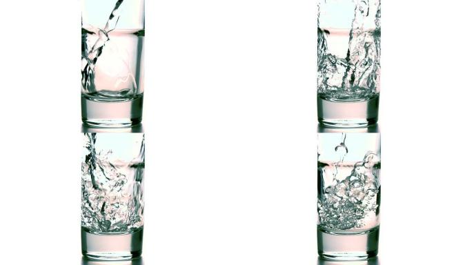 水倒入白色背景的玻璃杯中