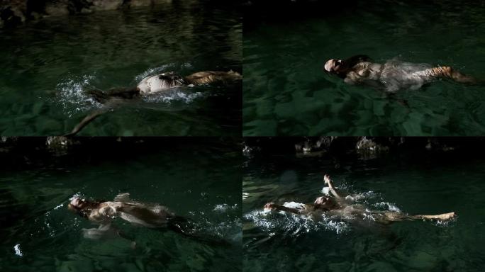 在天然水池里游泳的女人