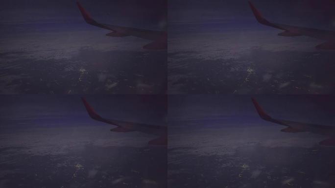夜城上空的喷气式飞机机翼