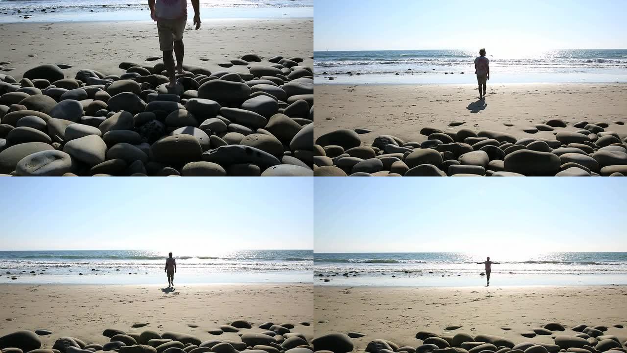 男子走在海岸线岩石上