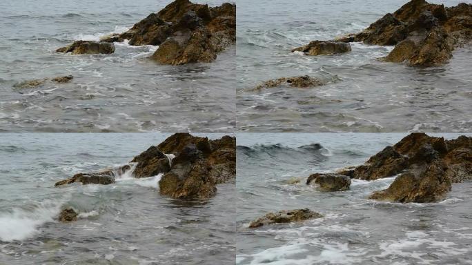 岩石披风大海边浪花海岛拍打石头礁石