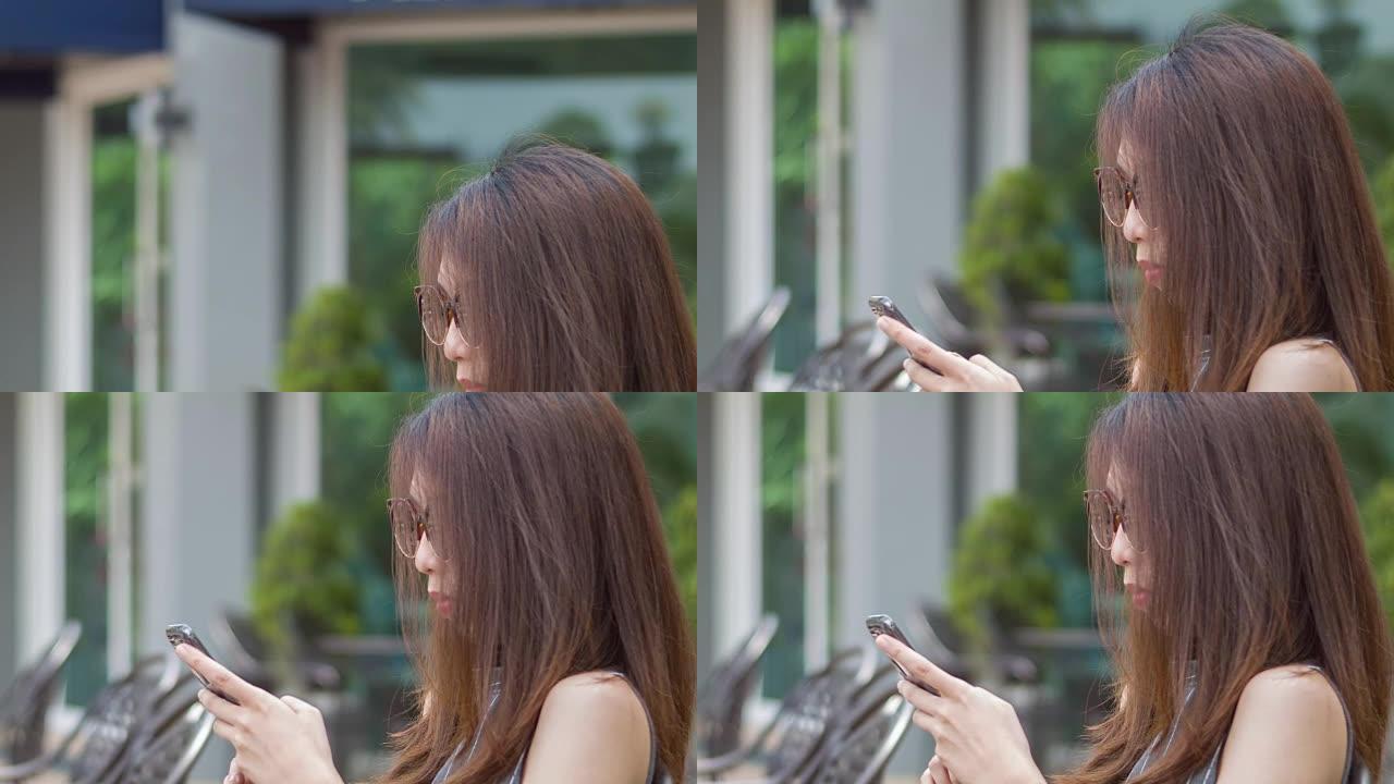 使用智能手机的年轻亚洲女性