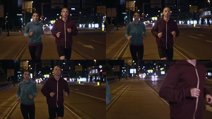 SLO MO TS夫妇在夜间在城市街道上奔跑