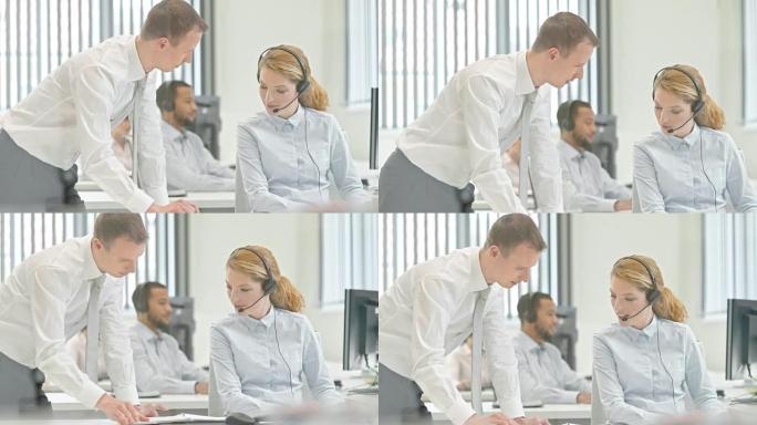 男性呼叫中心主管为他的女同事提供建议