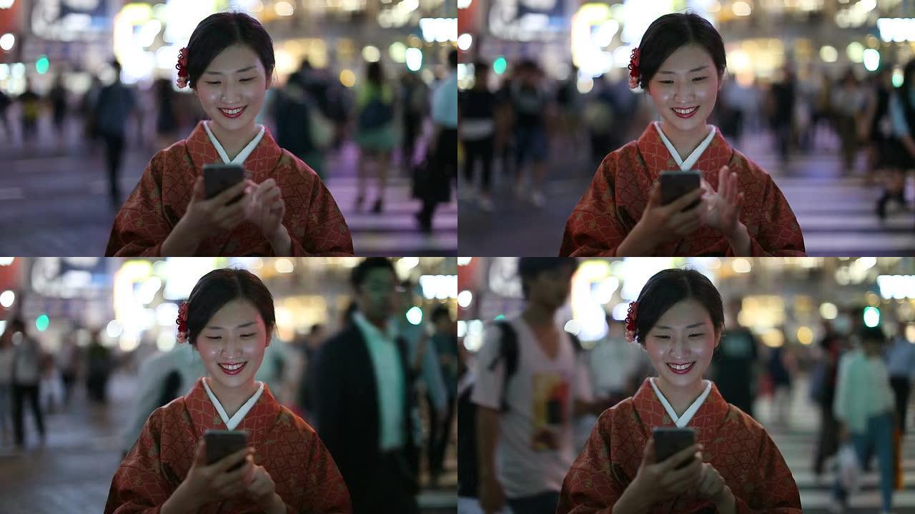 穿着和服的日本女孩在涩谷十字路口发短信