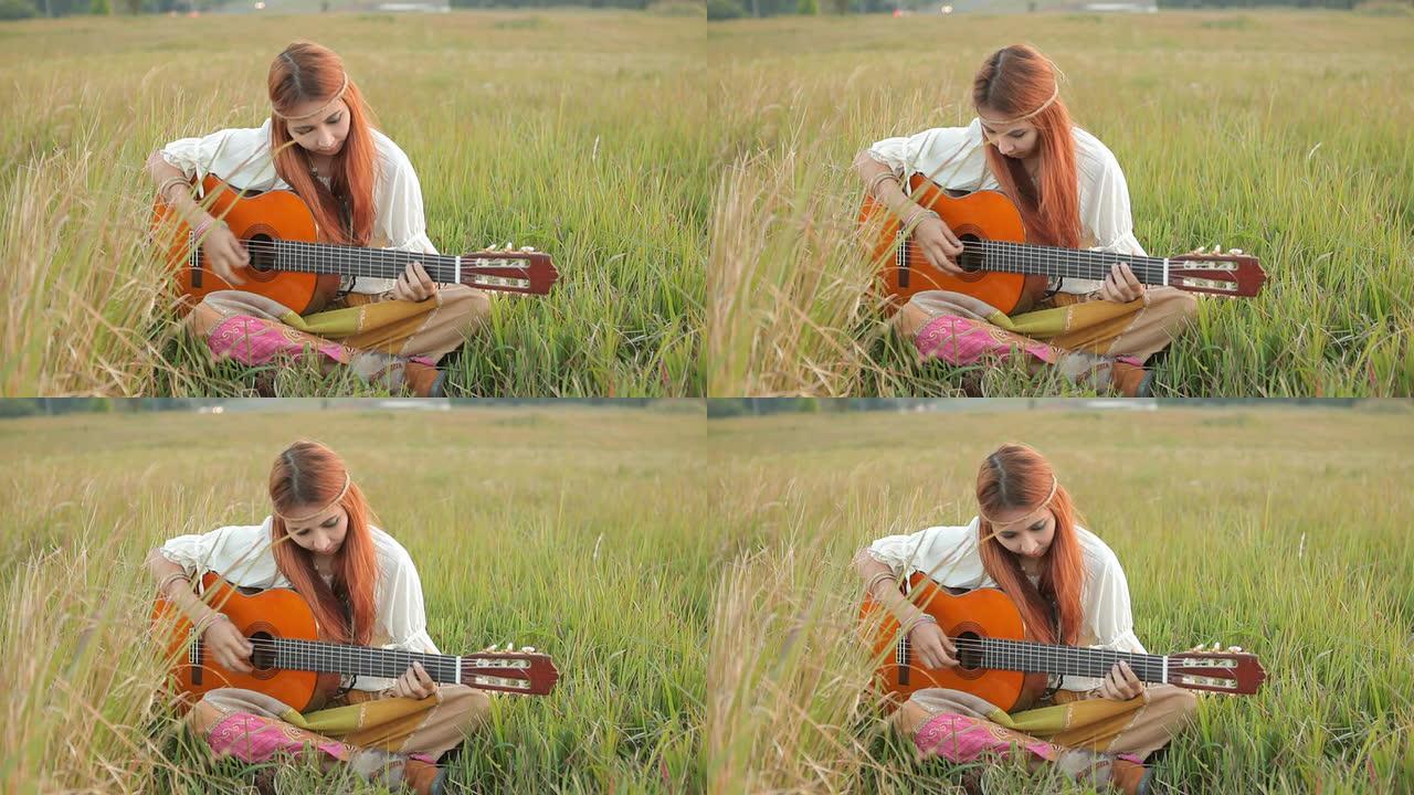 嬉皮士女孩在草地上弹吉他