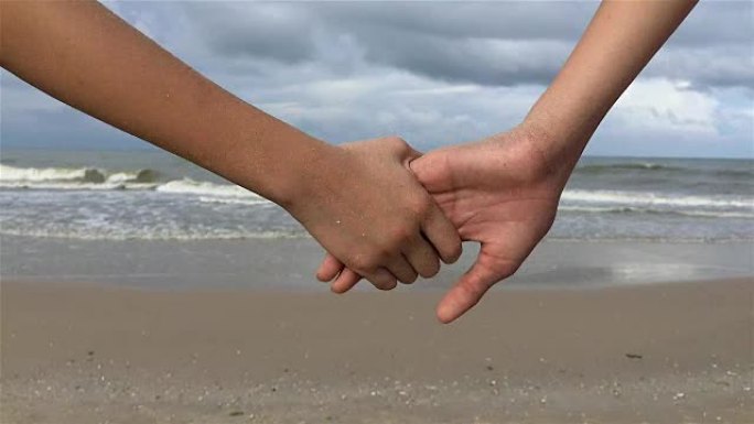 海滩上的人手牵手