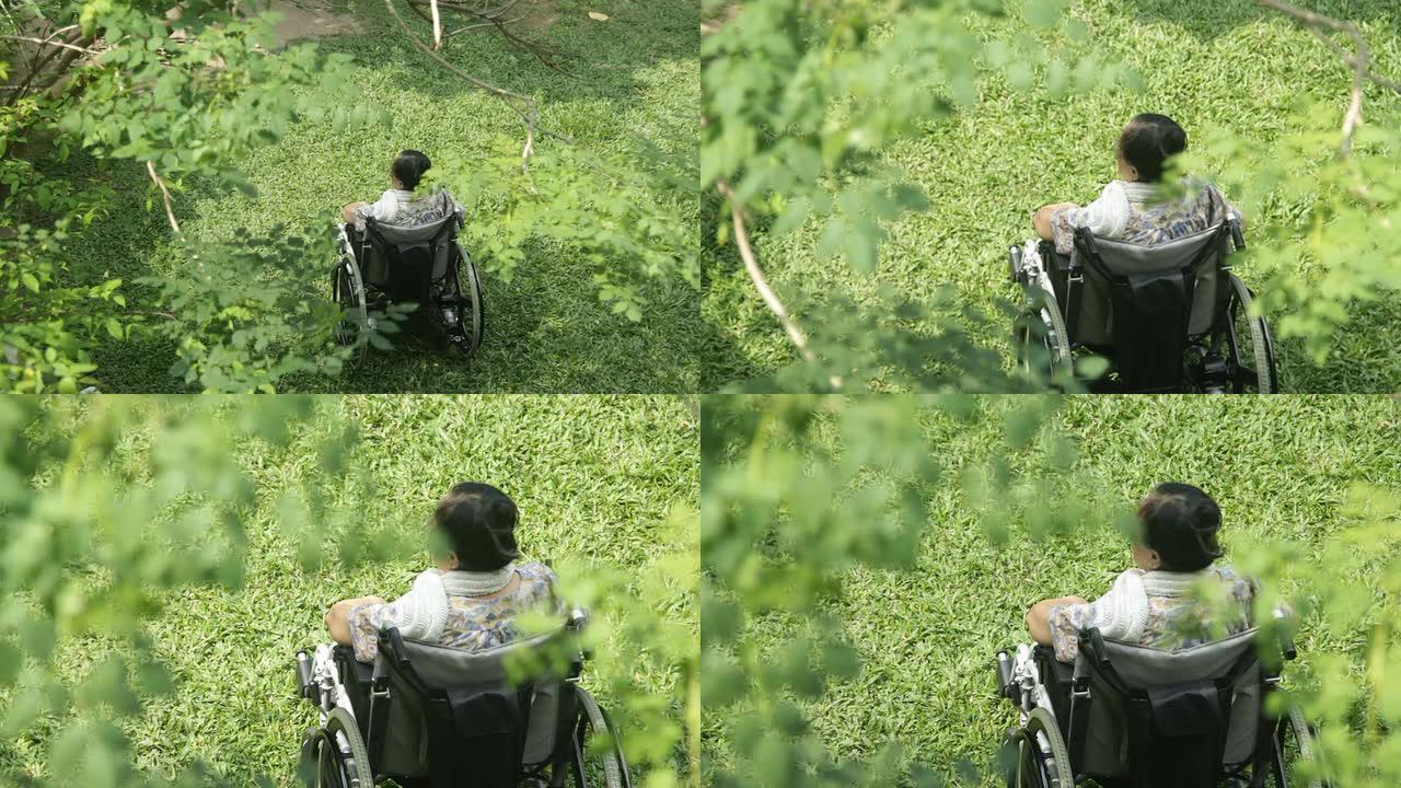 坐在轮椅上的亚洲老年妇女