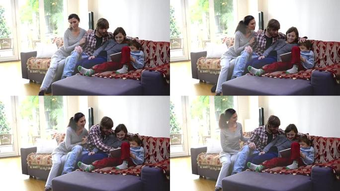 快乐的土耳其家庭在家里一起玩数字平板电脑