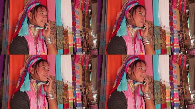 女人穿着传统的手机在村里编织