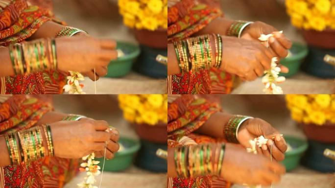 一个印度女人用美丽的茉莉花做花环