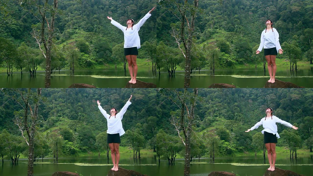 热带雨林中呼吸新鲜空气的年轻女子