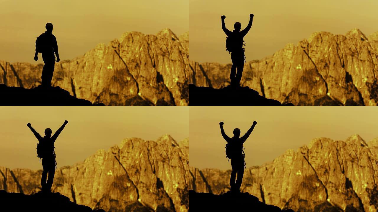 高清: 快乐的登山者在胜利中举起手臂