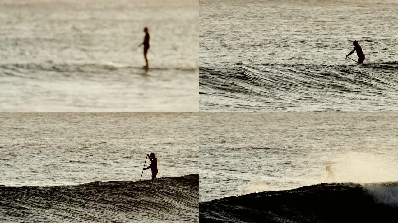 日落时分，海上的立式桨板冲浪者